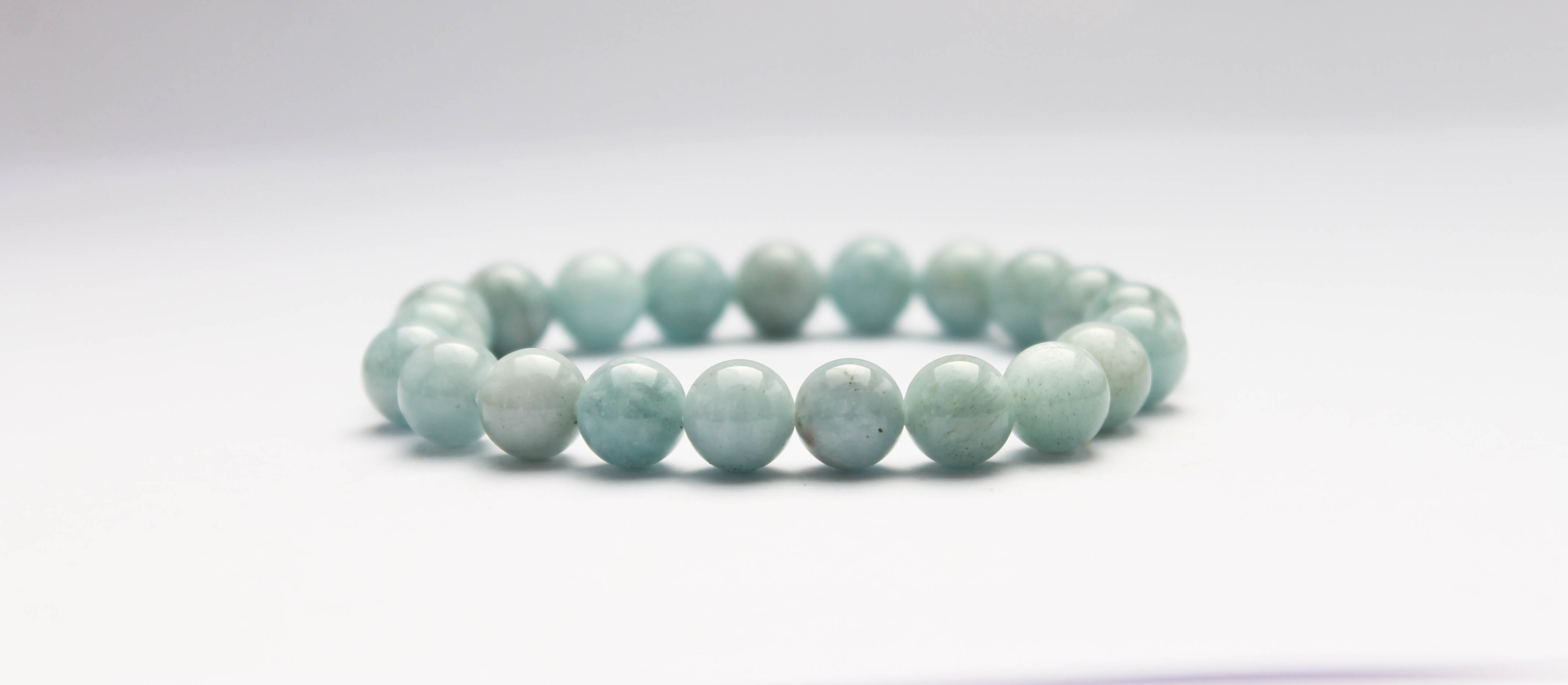 EvaDane Natural Aquamarine Beryl Gemstone Rope Bead Awareness Ribbon Charm Stretch Bracelet EvaDane Natural Aquamarine Beryl Gemstone Rope Bead Awareness Ribbon Charm Stretch Bracelet